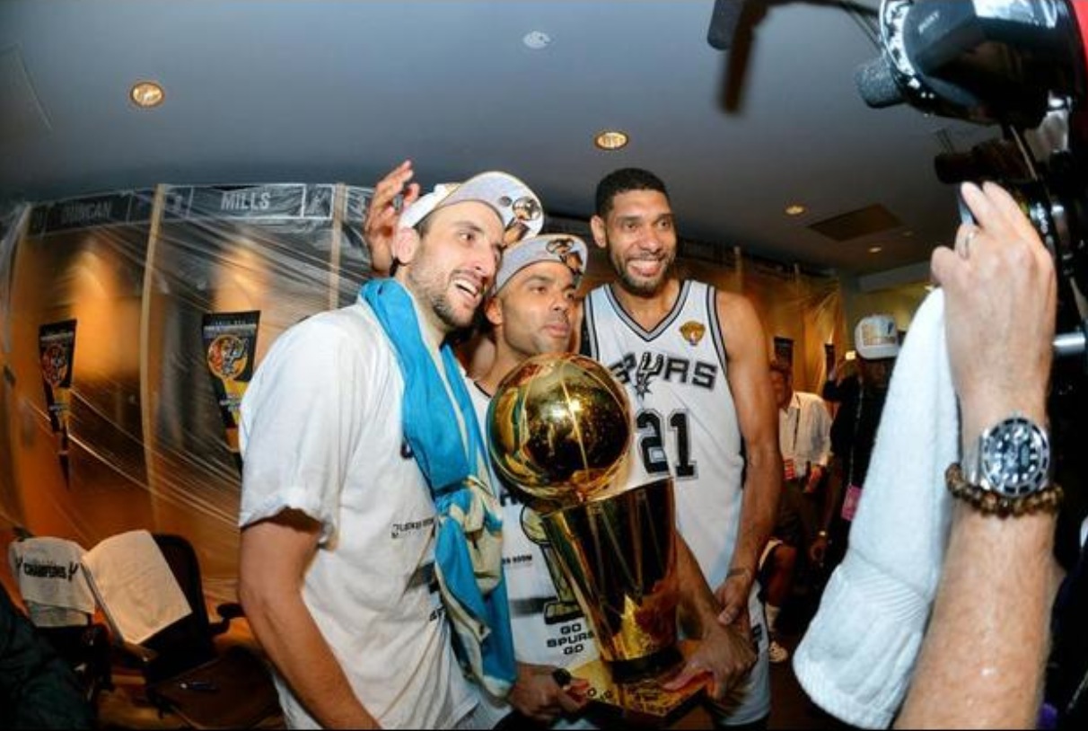 Manu Ginobili, Tony Parker and Tim Duncan of the San Antonio Spurs celebrate with the Larry O'Brien trophy after defeating the Miami Heat to win the 2014 NBA Finals in Game Five of the 2014 NBA Finals on June 15, 2014 at AT&T Center in San Antonio. Credit: Jesse D. Garrabrant/NBAE/Getty Images